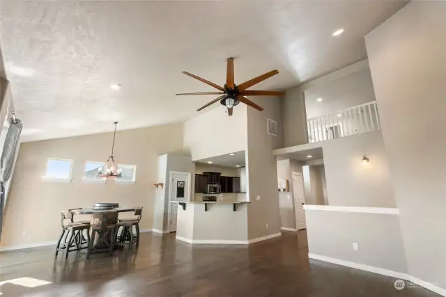 Living room with view to dining room, kitchen, and second floor