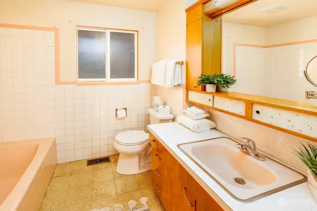 How cool is this bathroom?!  Original cabinets and tile work. Don't miss the large storage closet for your towels and supplies right behind the door.