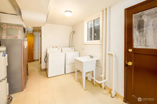 Large laundry and utility room.  The door leads out to the backyard for convenient access.