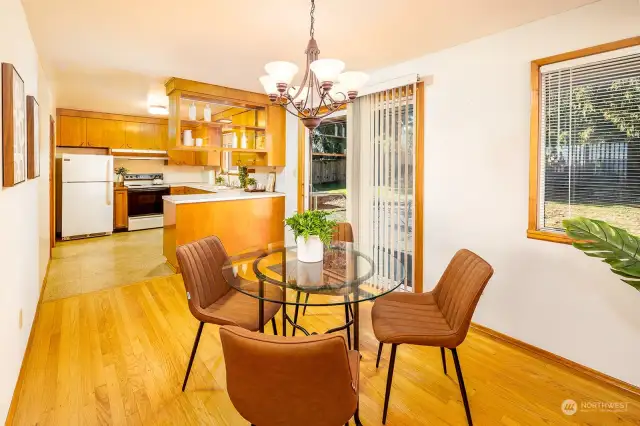 The dining room looks out onto the expansive private back yard. Shown here with seating for 4, but this space can easily accommodate a table for 8 comfortably.