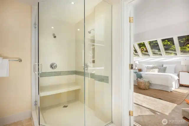 Spacious shower with dual showerheads, ceramic tile, and glass enclosure!