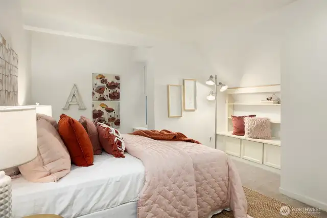 Bedroom #3 features views of towering trees and a cozy built-in nook—perfect for reading and extra storage.