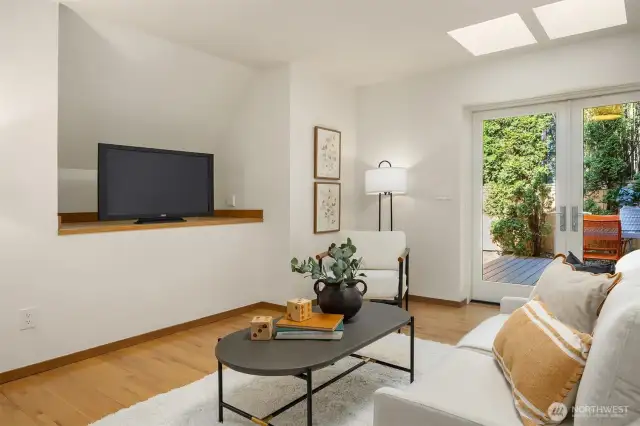 Bright and versatile space just off the kitchen, with natural light from adjacent French doors and easy access to the nearby entry. Currently a casual hangout area, but easily converted back to an in-kitchen dining space.