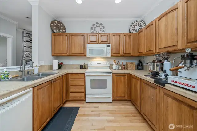 Kitchen as seen from laundry room. Half bath and entryway seen to the left.