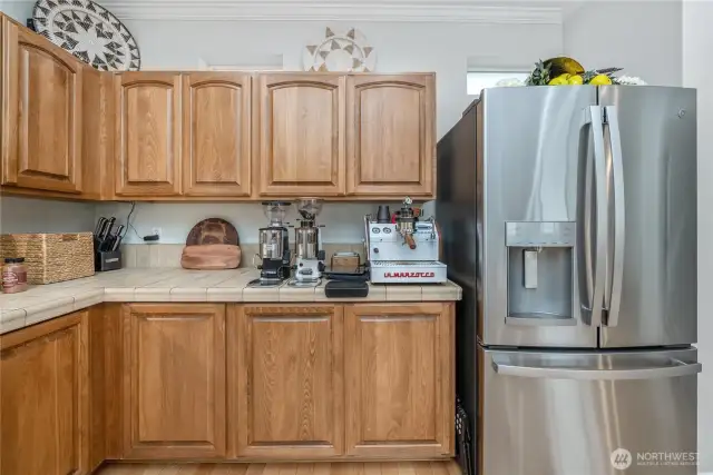 Extra natural light in the kitchen with small windows above the cabinets.