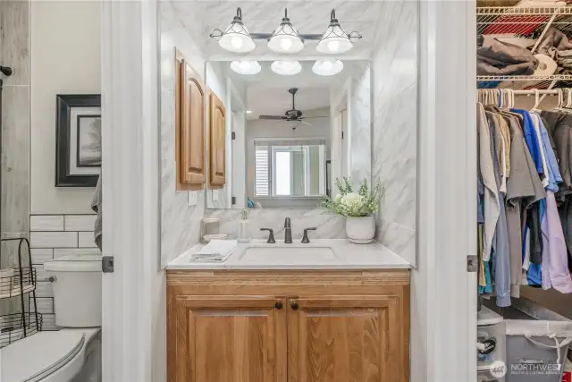 Bathroom vanity separated from the shower allow multiple people to get ready simultaneously. Large walk-in closet complete this primary suite.