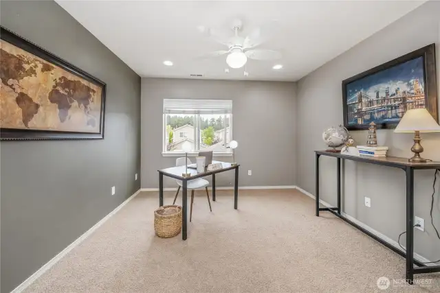 First bedroom at the top of the stairs, staged as an office but plenty large enough for a queen size bed.