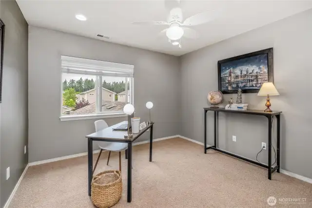 First bedroom at the top of the stairs, staged as an office but plenty large enough for a queen size bed.