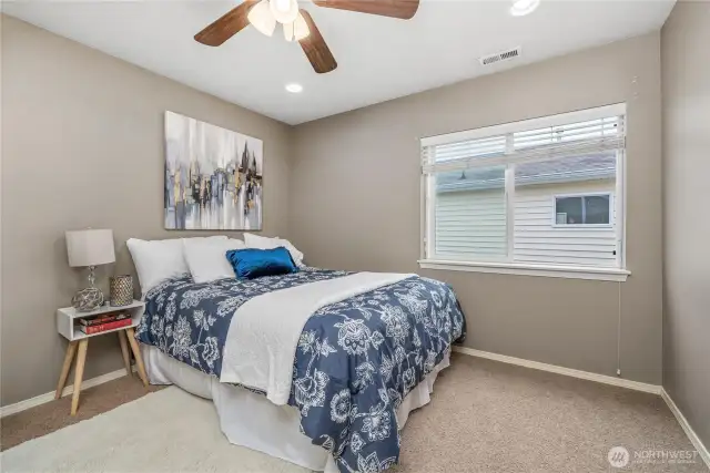 Lots of space at the foot of this queen size bed for a dresser and a large walk-in closet complete this second upstairs bedroom!