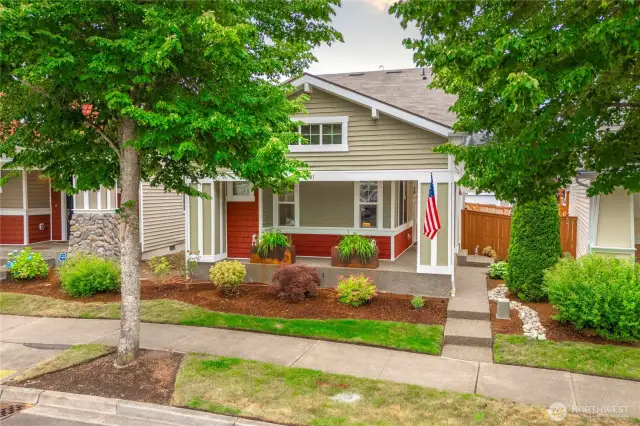 Concrete porch wraps around the full front of house and side all the way to the fenced yard.