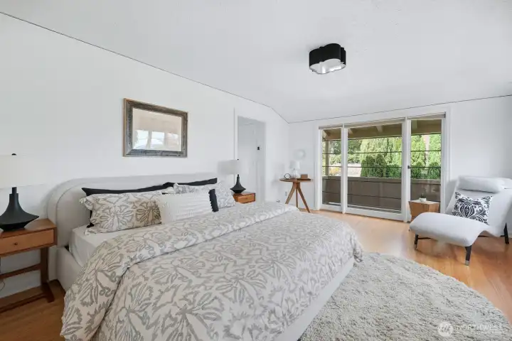 Primary suite upstairs. This is a king-sized bed with room for seating as well. The Juliet balcony is the perfect spot to enjoy a morning beverage or an evening glass of wine.