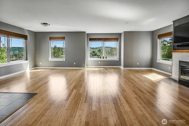 Staging has been removed. Enter into large living space with bamboo flooring