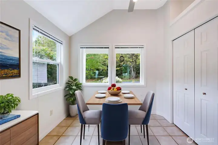 A virtually staged look at one way you could arrange the breakfast nook in the kitchen area. A round table would be terrific, as would a small loveseat and coffee table. Use your imagination for this flexible space.
