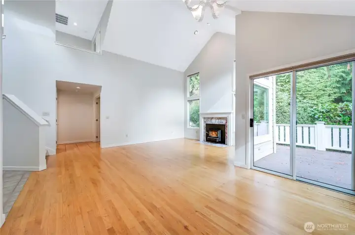The main living area is spacious and freshly painted throughout. The sliding door from the dining area leads to your private deck. In the background is the entry to the large primary ensuite. Stairs on the left lead to the loft.