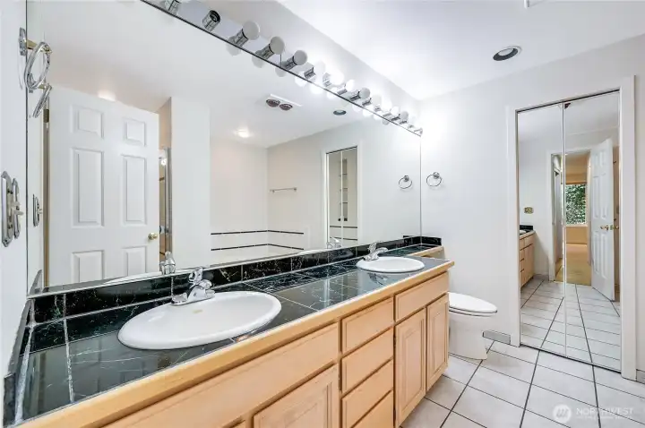 the primary bedroom has a large private bath with dual sinks, a separate shower, soaking tub and ample storage space.