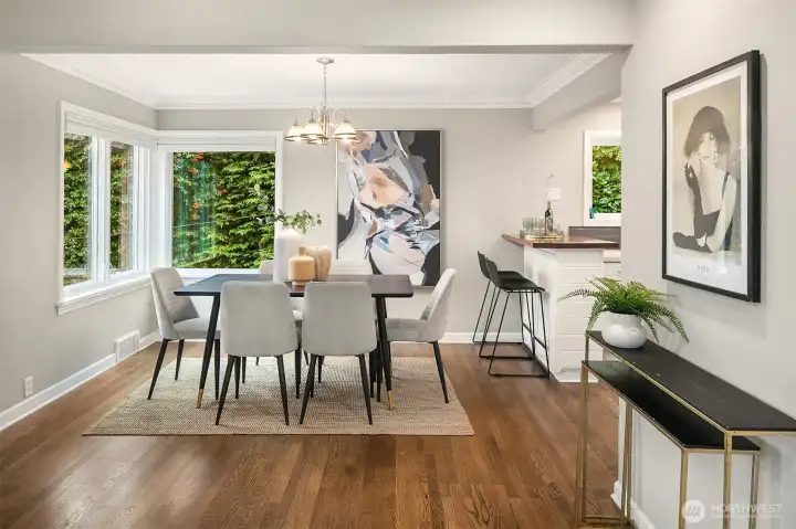 The dining room has a corner wall of windows facing east and south