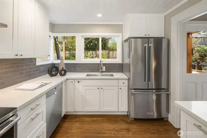 Gaze out to the beautiful west facing back yard when standing at the kitchen sink. Doors to the yard are just to the right
