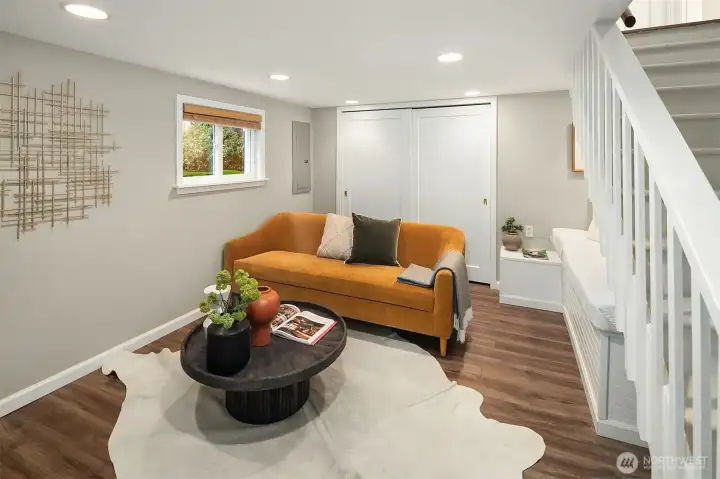 At the base of the stairs is a cozy room great for TV watching or a home office.