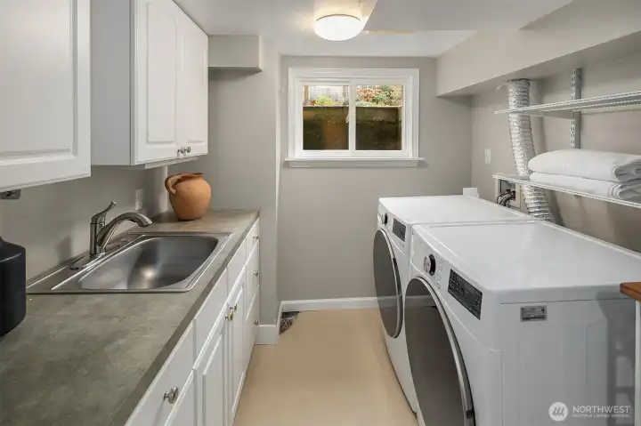 Laundry room with sink and abundant cabinet and counter space.  Could become a second kitchen?