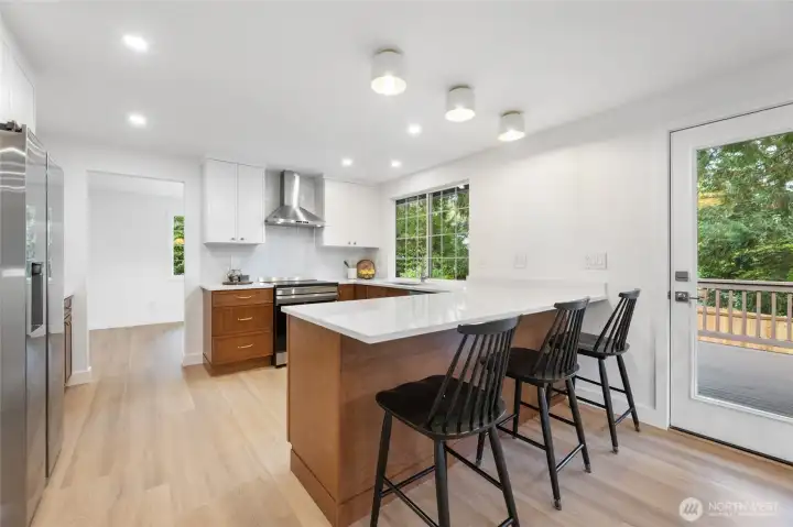 Completely remodeled bright kitchen includes new quartz countertops, new Samsung stainless appliances and updated lighting.