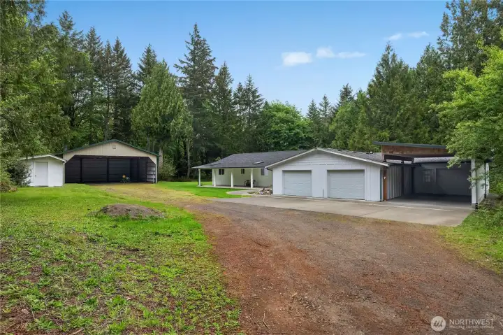 Covered parking galore! A carport, a garage with checkered floor, a two-car attached garage, a 40x40 shop to hold at least 4 large vehicles, plus a work shed.