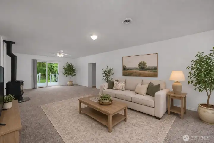 Virtually staged living room, shows dining space near the slider to the deck.