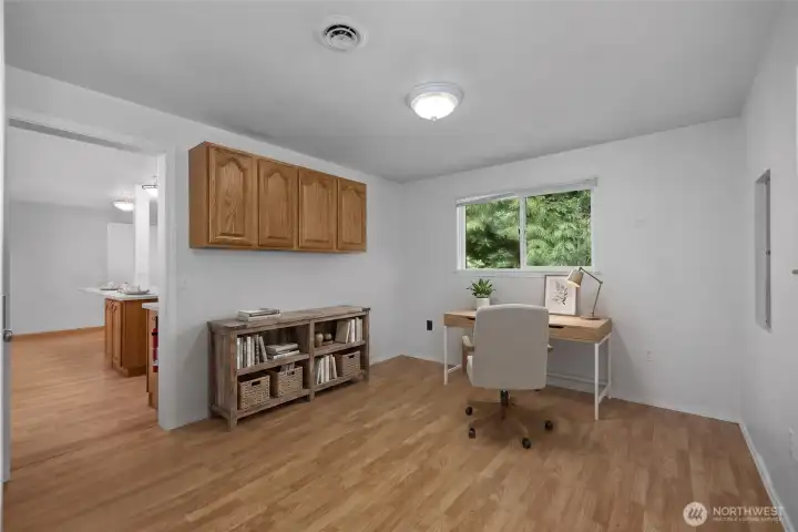 Virtually staged office - just off the checkered floor garage and the utility.