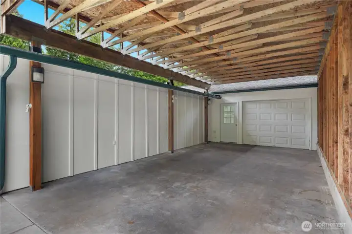 Carport and door to the checkered floor single car garage.