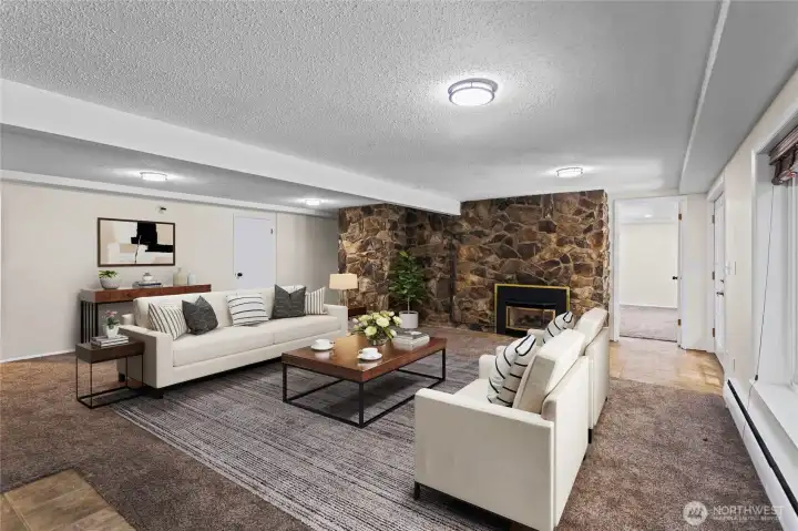 Another angle of downstairs great room.Room to the right of the fireplace was used by the current owners as a private work from Home office.Virtually staged