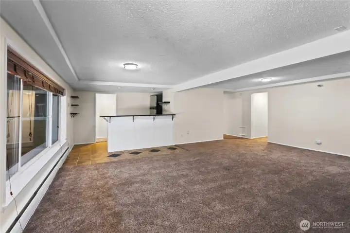 Downstairs Great Room looking back towards Wet Bar complete with Stainless Steel Refirigerator/Freezer
