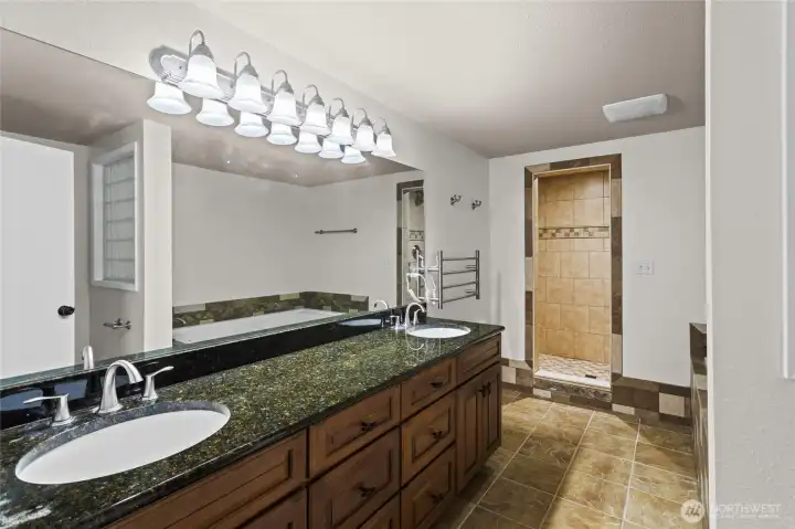 Lower Primary suite with Heated Towel Rack,Walk in Tiled Shower and Jetted tub.