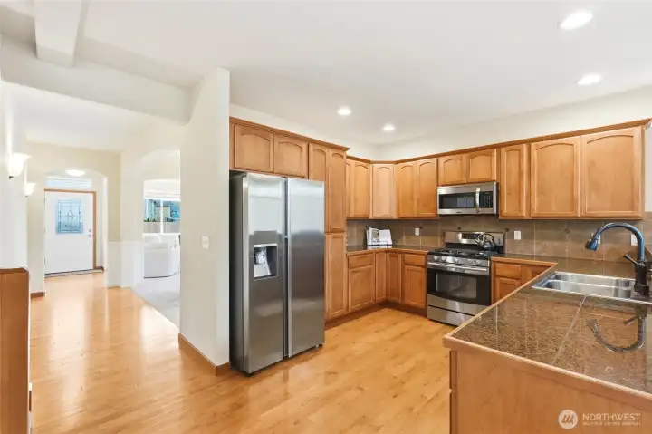 Kitchen with granite counters, stainless steel appliances, and gas range Kitchen with granite counters, stainless steel appliances, and gas range