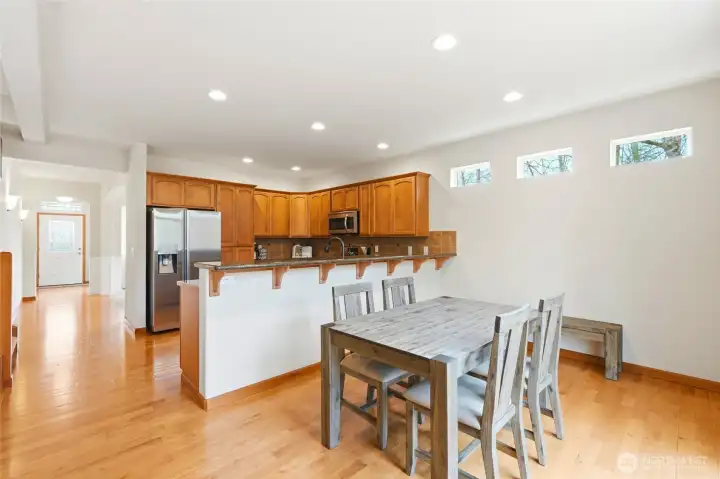 Open-concept kitchen and family room with hardwood floors and greenbelt views Open-concept kitchen and family room with hardwood floors and greenbelt views