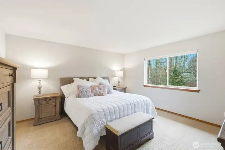 Upstairs, the primary suite overlooks the greenbelt and includes a five-piece bath with soaking tub and a spacious walk-in closet. Upstairs, the primary suite overlooks the greenbelt and includes a five-piece bath with soaking tub and a spacious walk-in closet.