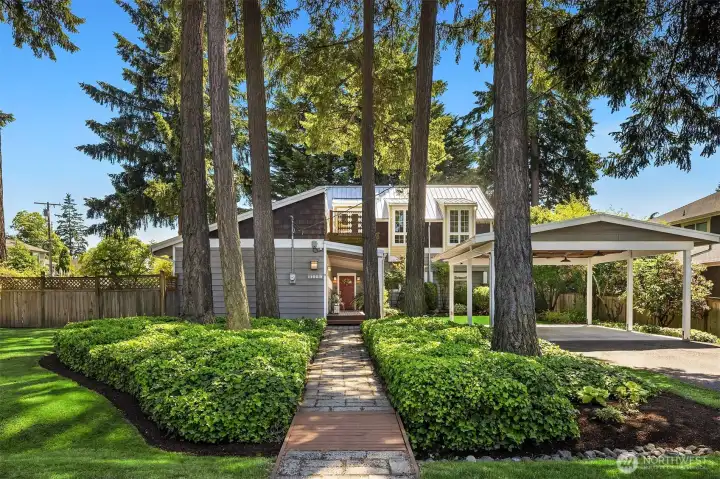 A rare corner-lot setting in the heart of Enatai, where towering evergreens, manicured grounds, and timeless architecture create an unforgettable first impression.