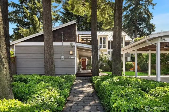 A rare corner-lot setting in the heart of Enatai, where towering evergreens, manicured grounds, and timeless architecture create an unforgettable first impression.