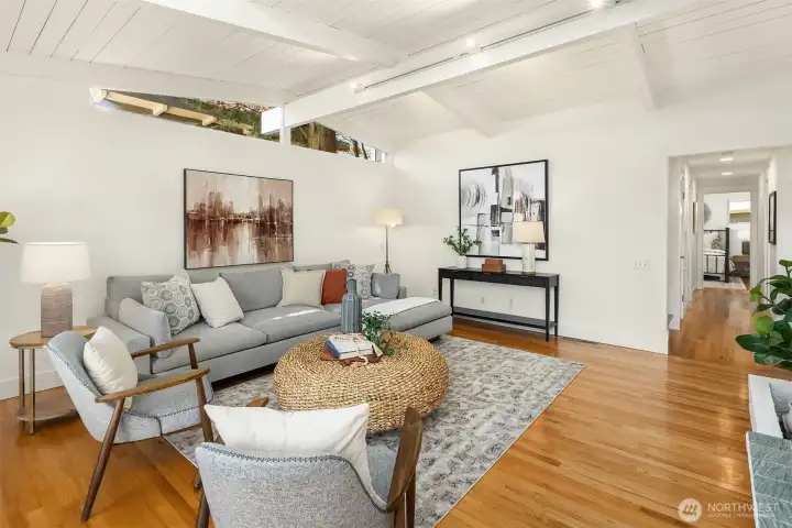 Clean architectural lines, vaulted ceilings, and expansive gathering spaces create a light-filled living room that feels both open and inviting.