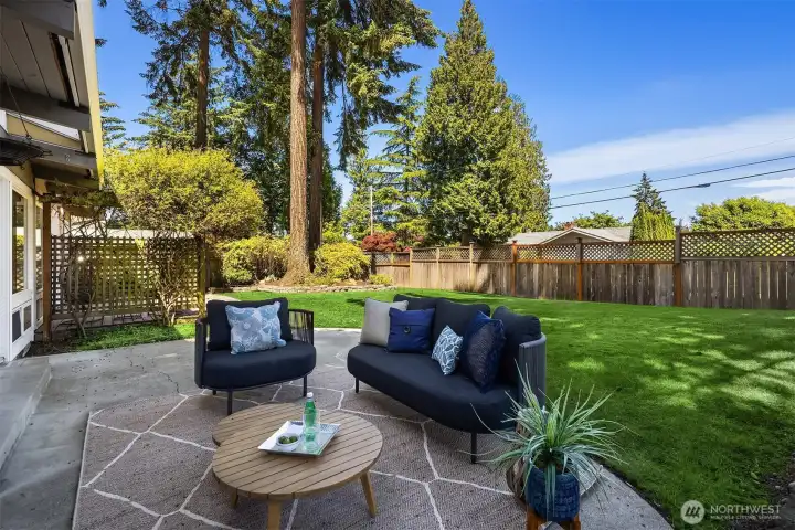 Privately positioned with eastern exposure, the patio offers a quiet retreat for morning coffee, sunlit lounging, and seamless connection to the expansive backyard beyond.