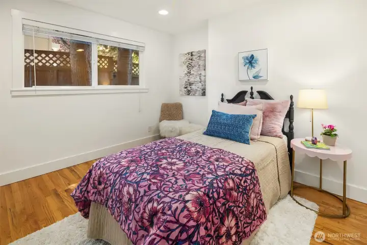 A secondary main-level bedroom with an adjacent nook offers flexibility for guests, a nursery, study space, or cozy work-from-home setup.