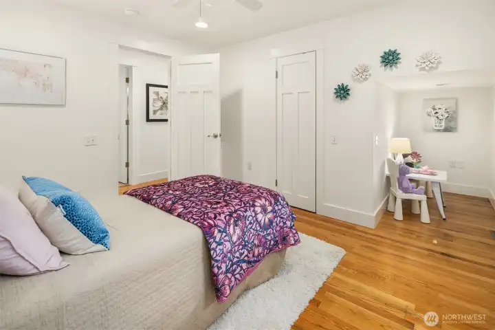 A secondary main-level bedroom with an adjacent nook offers flexibility for guests, a nursery, study space, or cozy work-from-home setup.