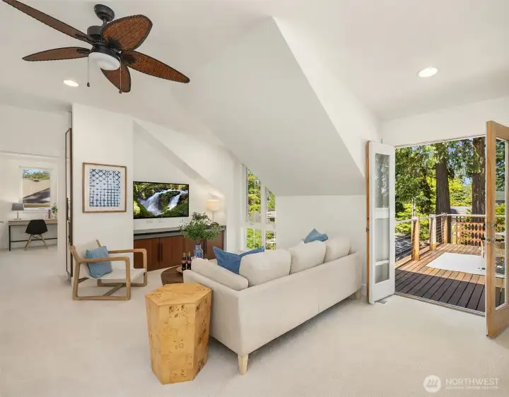 The vaulted upper-level bonus room opens to a west-facing rooftop deck, creating a light-filled retreat for movie nights, work-from-home flexibility, or sunset lounging above the trees.