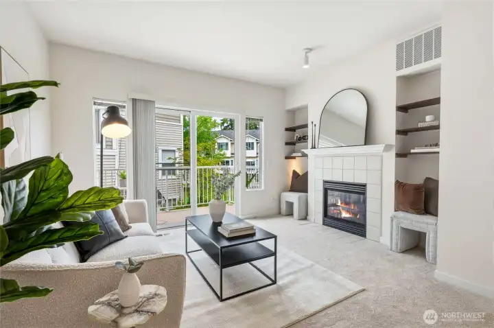 Generous living area with gas fireplace, built-in shelves, and a sliding door to the balcony!