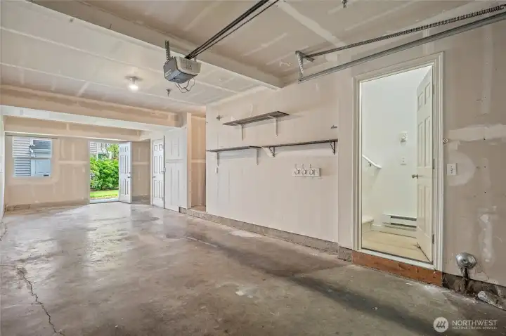 Two car garage with door to the covered patio at the far end.