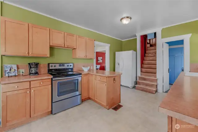 Lots of potential here by moving the refrigerator to the other side of the kitchen, then wall off the existing area to create a much easier access to the upper level through the dining room.