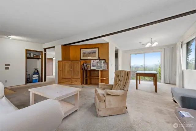 Another view of the living room and dining area that looks out to the valley and salt water bay views.