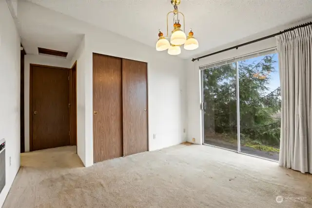 Looking at the dining room and the hallway toward the laundry room and beds/baths.