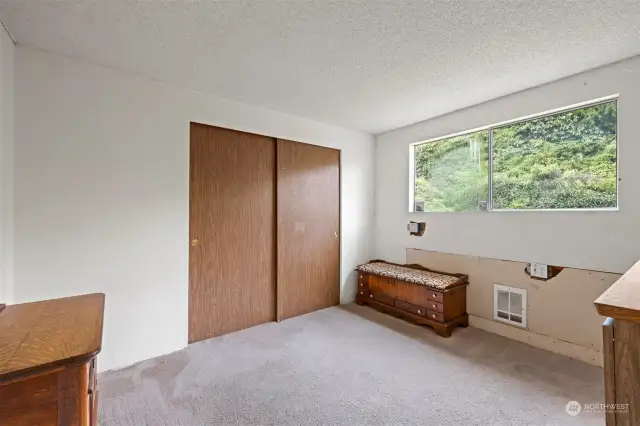 The second bedroom looks to the rear of the home, but is spacious.