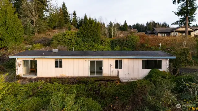 The rear elevation of the home with the newer homes above on Tulip Lane.