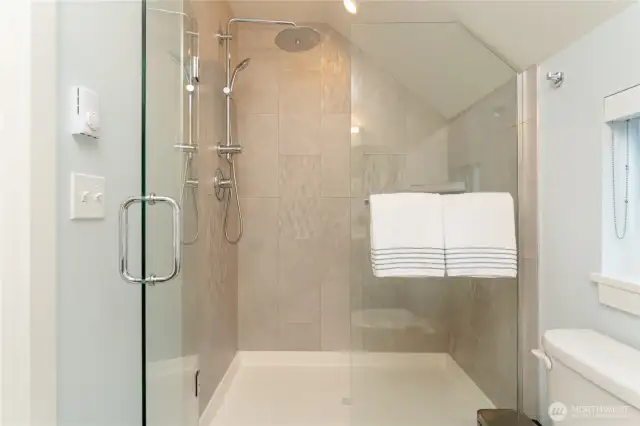 View 2 of Upper Level Primary Bedroom w/ on-suite bathroom w/ custom vanity and tile and glass shower.
