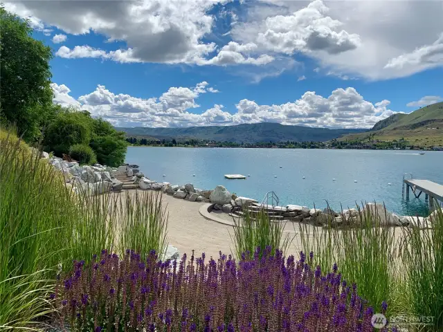View of The Lookout's private waterfront with sandy beach cove and swimming area.